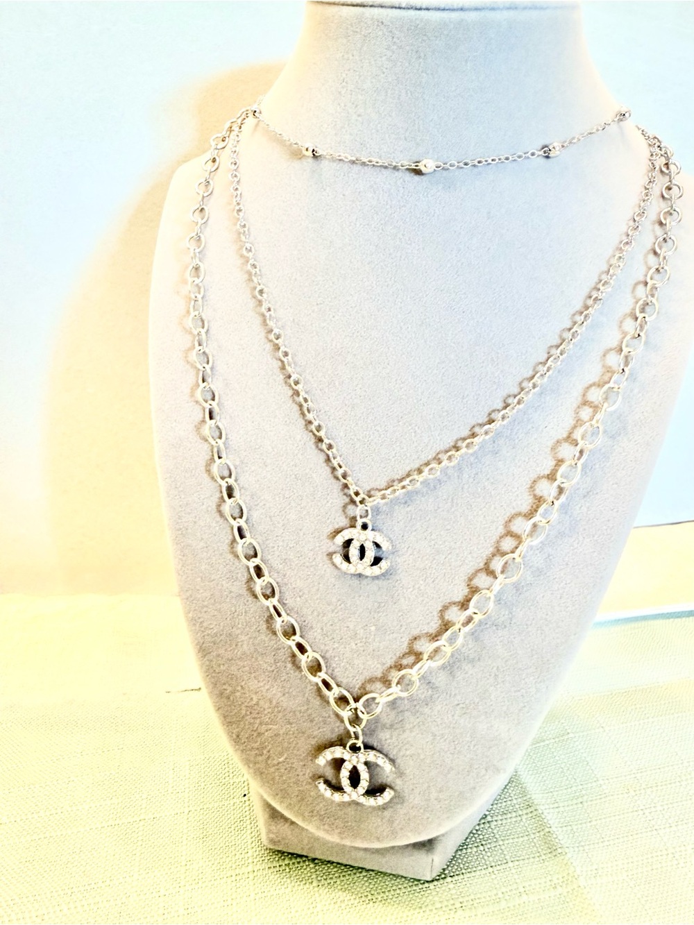 Layered Silver-Tone Triple Chain Necklace with Interlocking Emblem